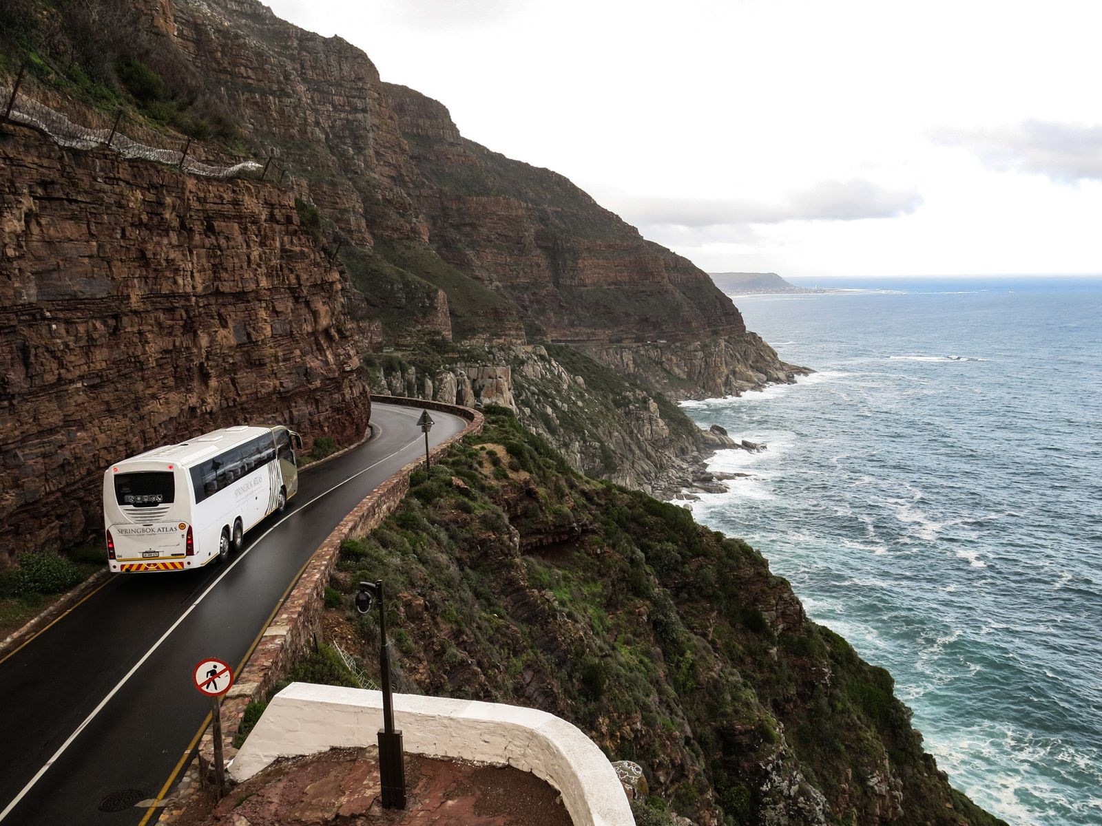 An intercity coach travelling a coastal highway